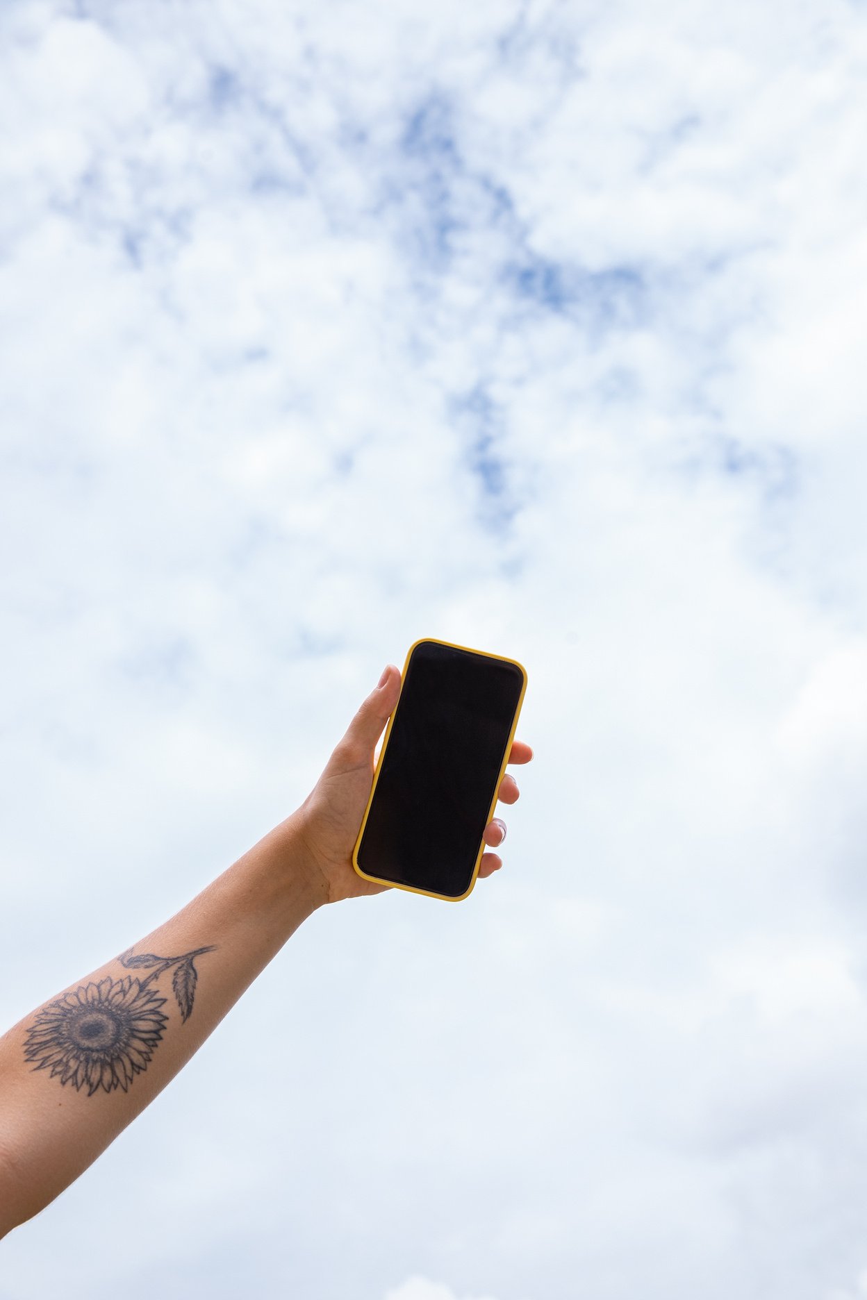 Outdoor Youths & Tech Hand Holding Phone Against the Sky